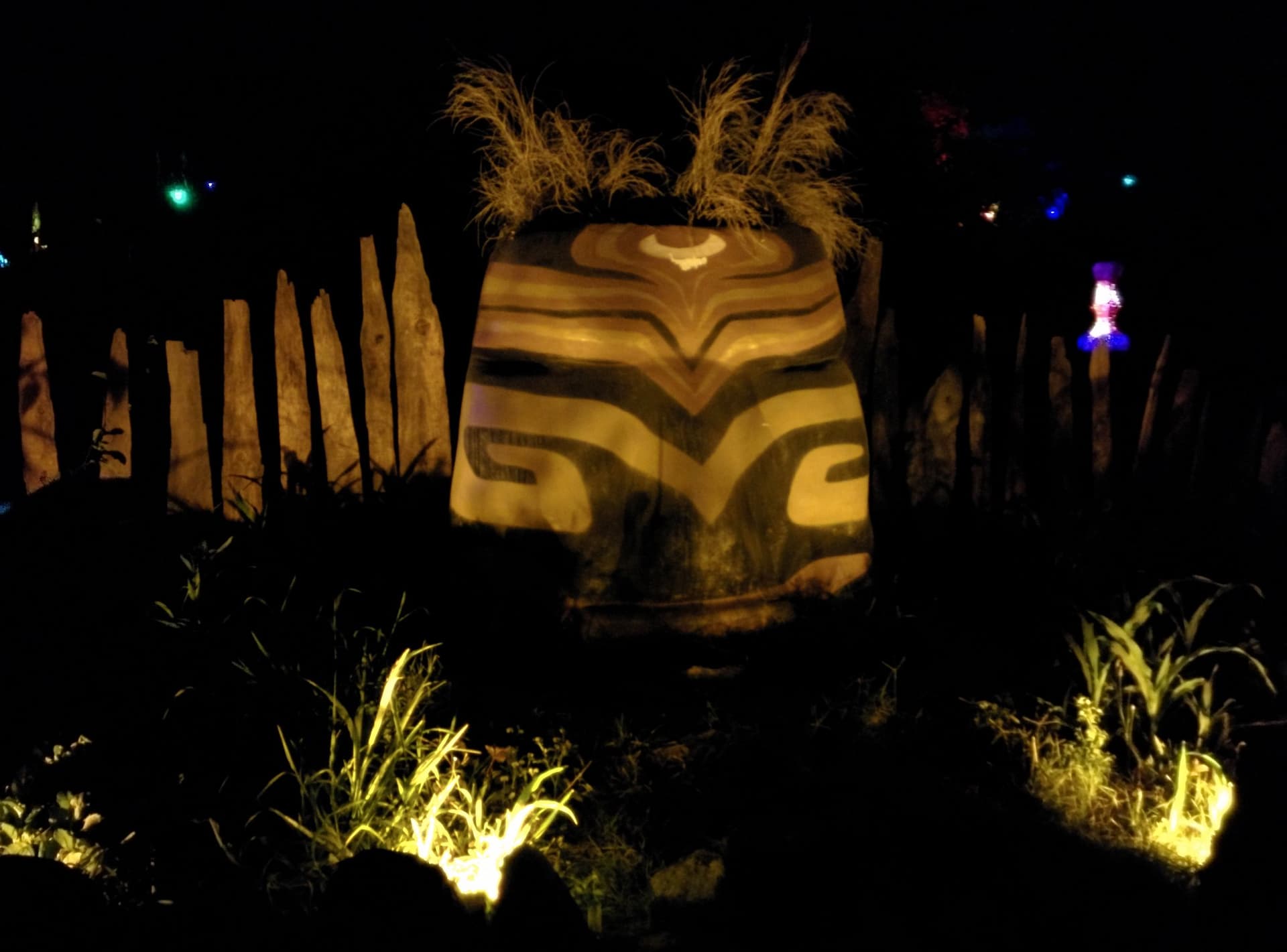 Lit sculpture among carved posts at night, Boom 2014