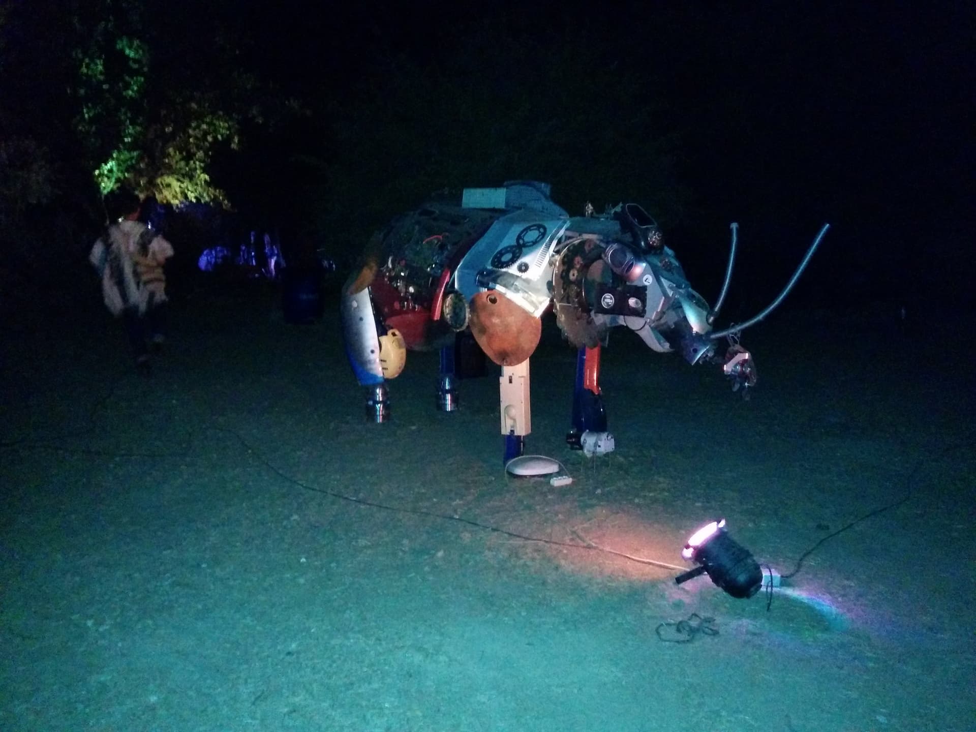 Lit creature sculpture on the ground at night, Boom 2014