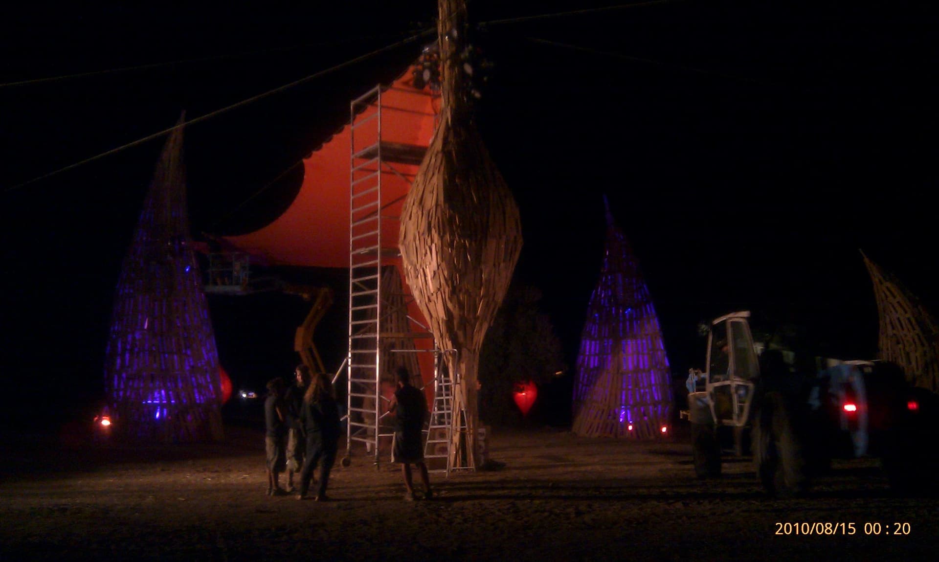Woven Dance Temple towers lit at night during the build, Boom 2010