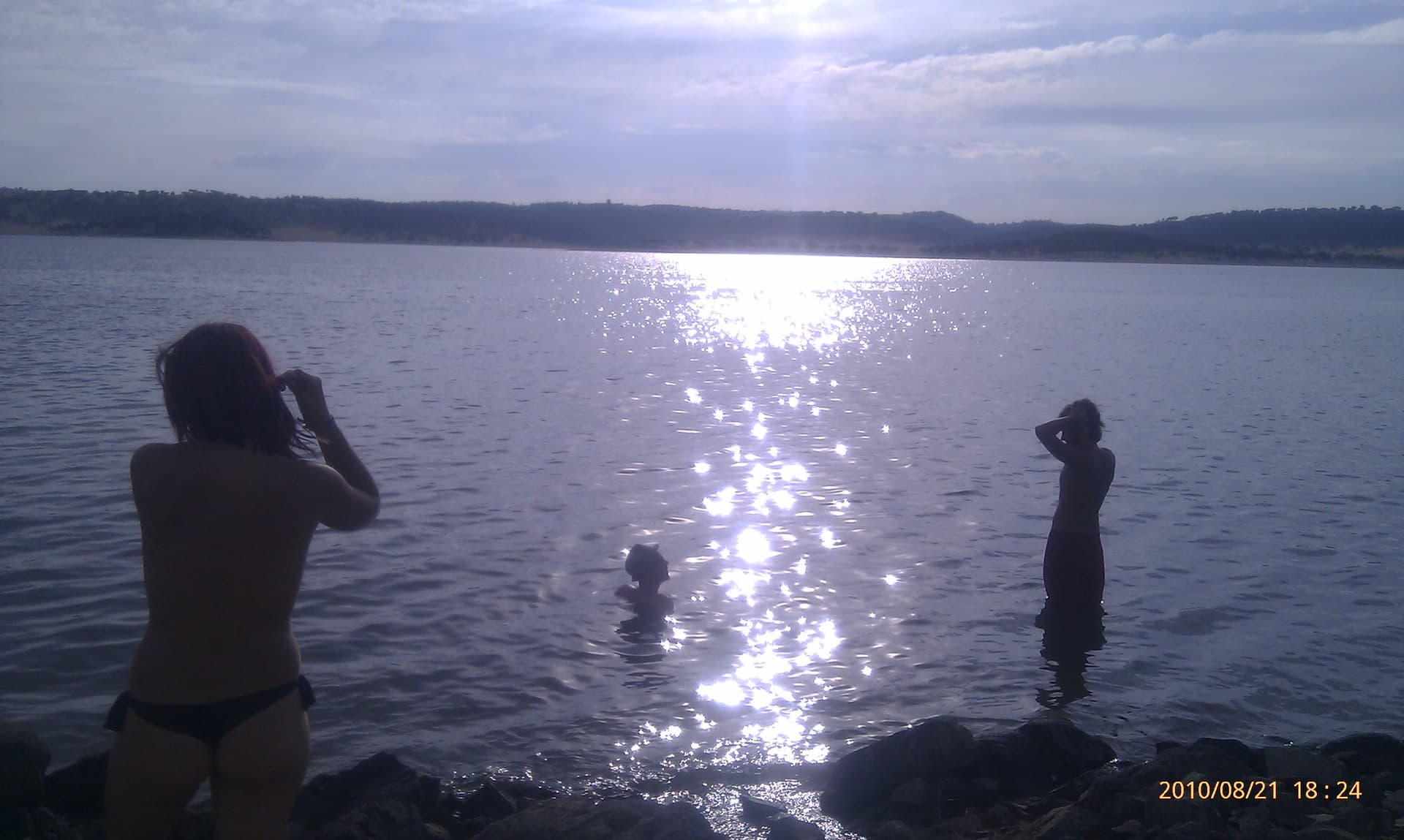 Bathers silhouetted on the sunlit water, Boom 2010