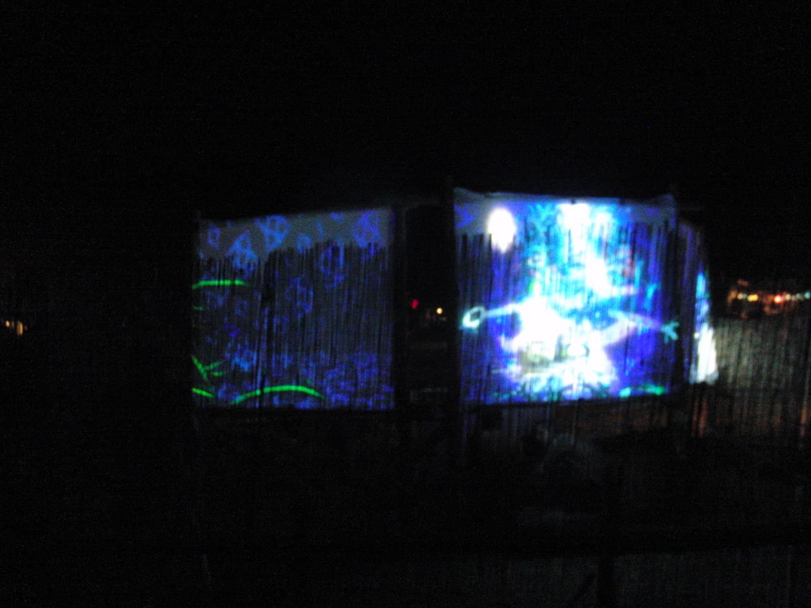 Projection glowing against the reed fence, Boom 2010