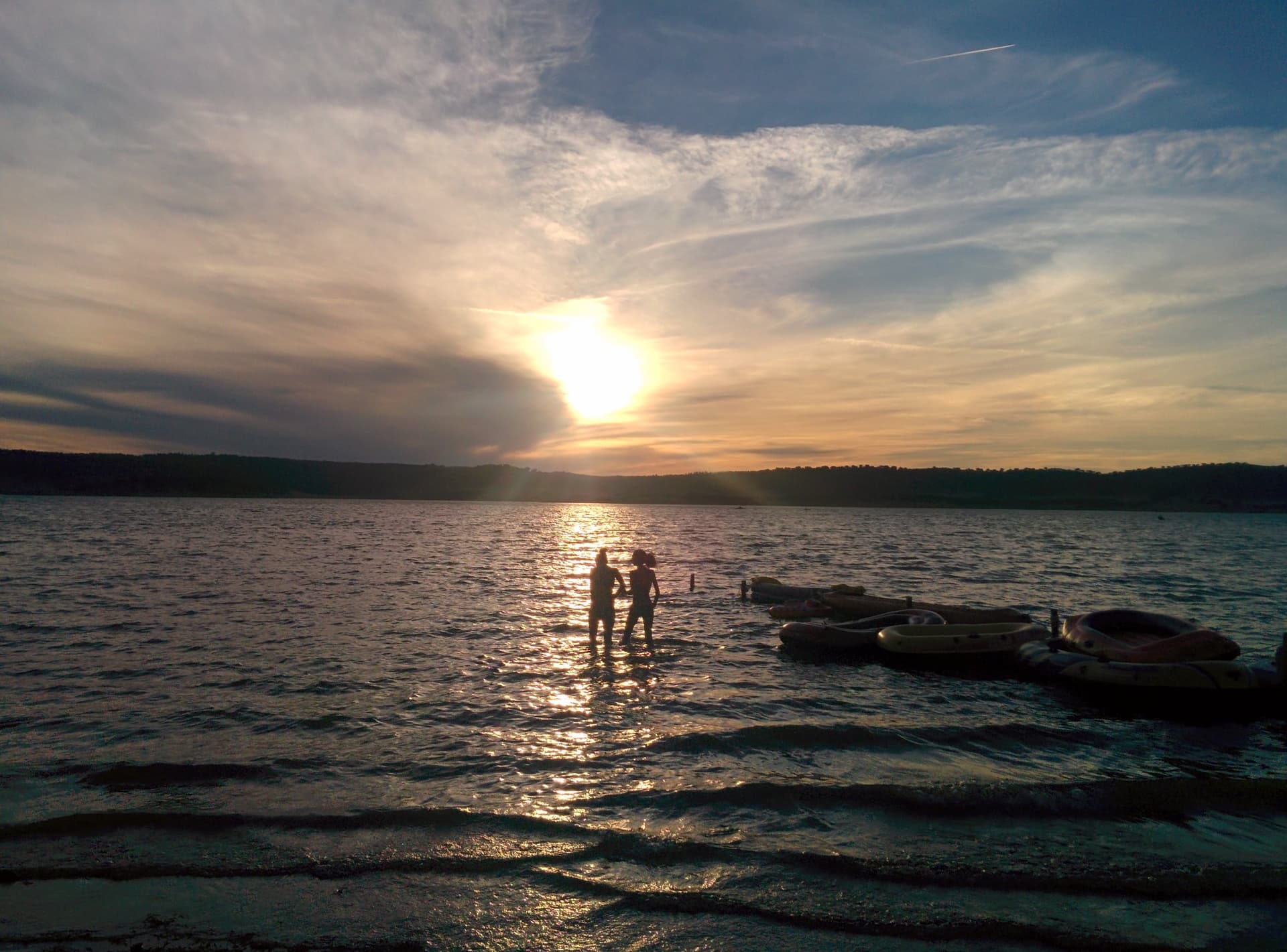 Sun setting behind bathers in the lake, Boom 2014