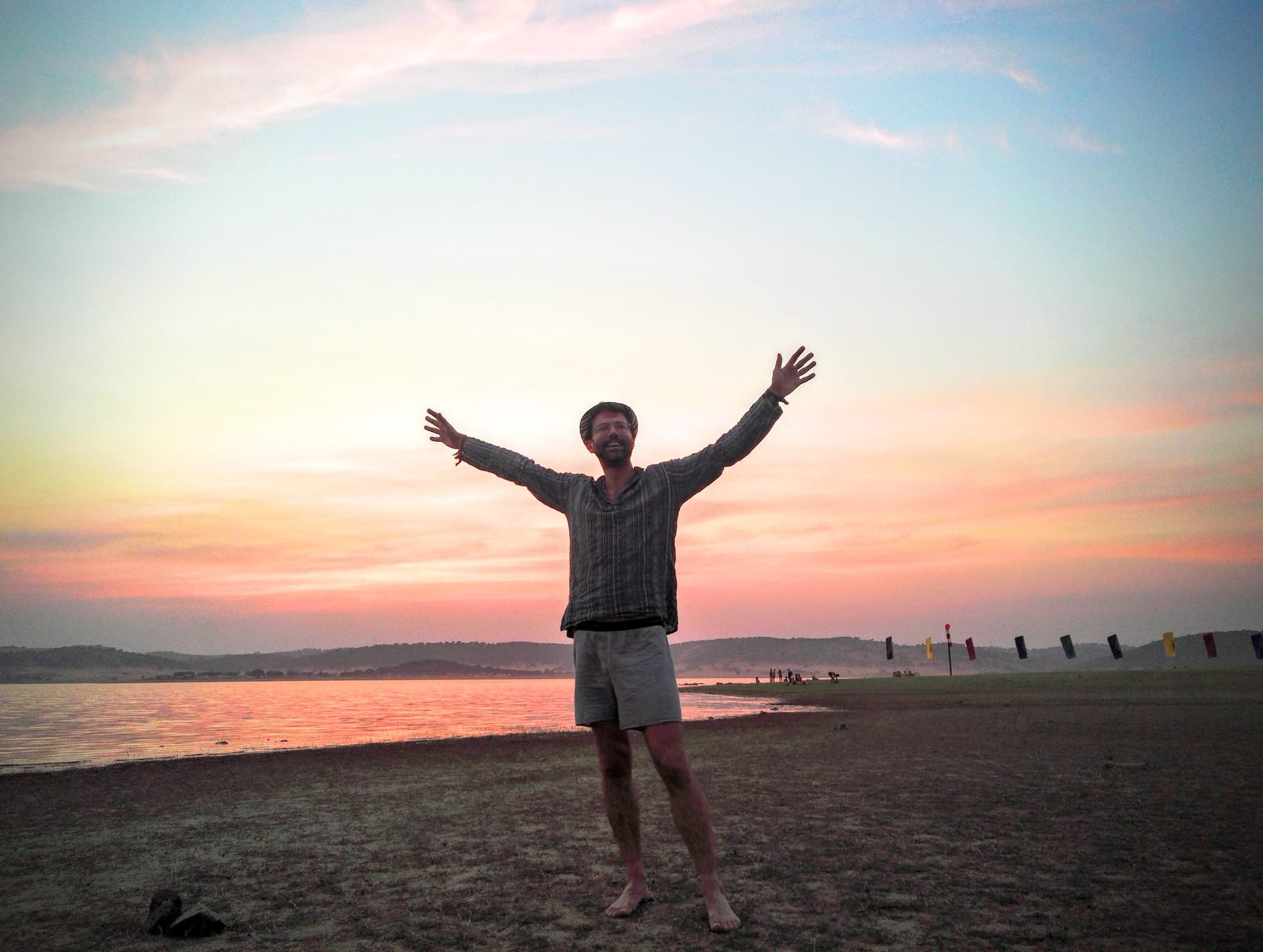 Arms raised at sunrise on the reservoir shore, Boom 2016