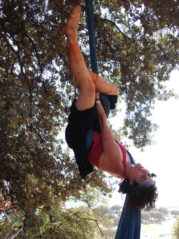 Aerial performer hanging from a tree