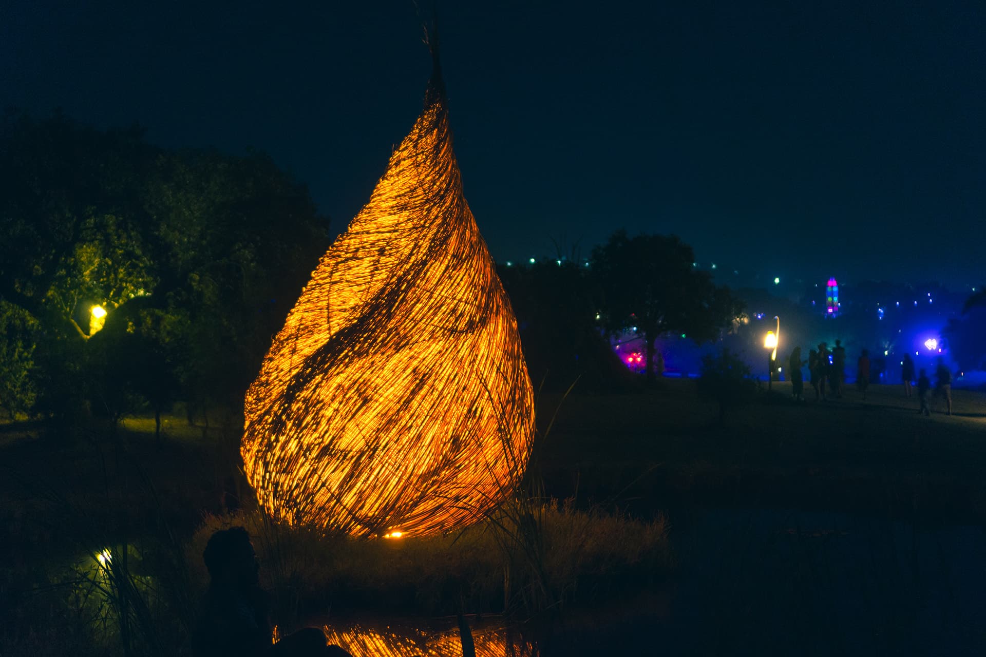 Woven flame sculpture lit at night