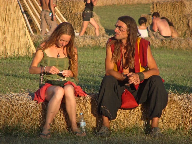 Two visitors sitting on straw bales