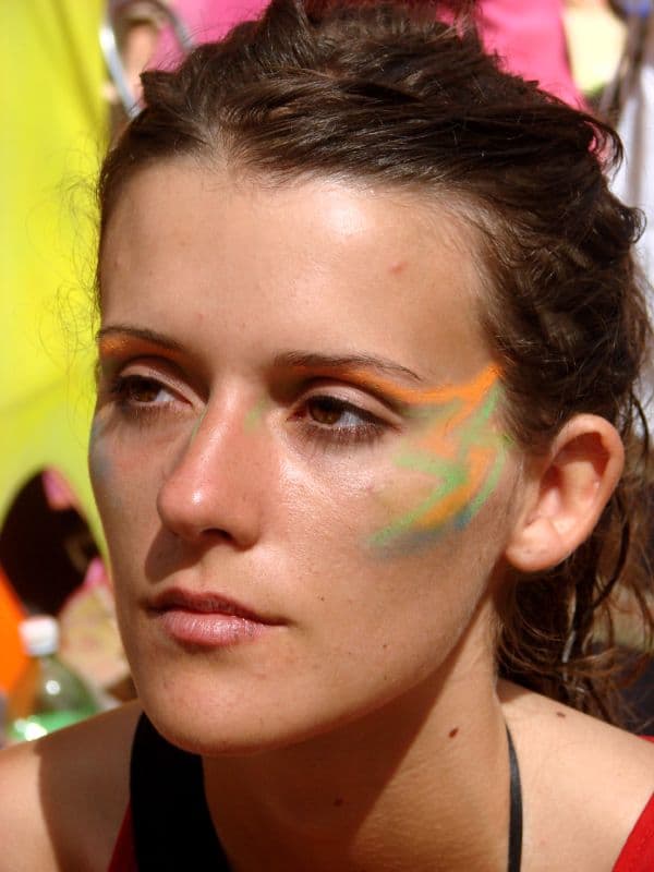 Visitor with green and yellow face paint