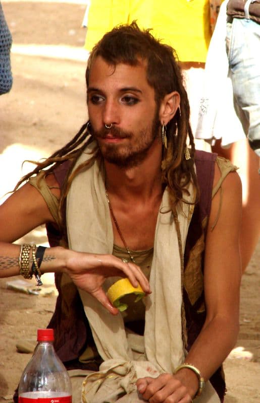 Visitor pouring a drink in the shade