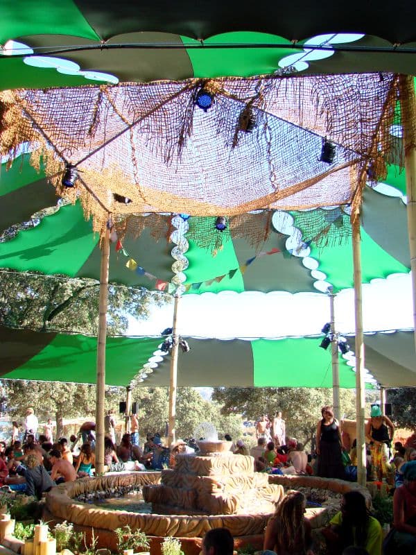 Green and white canopies over a gathering area