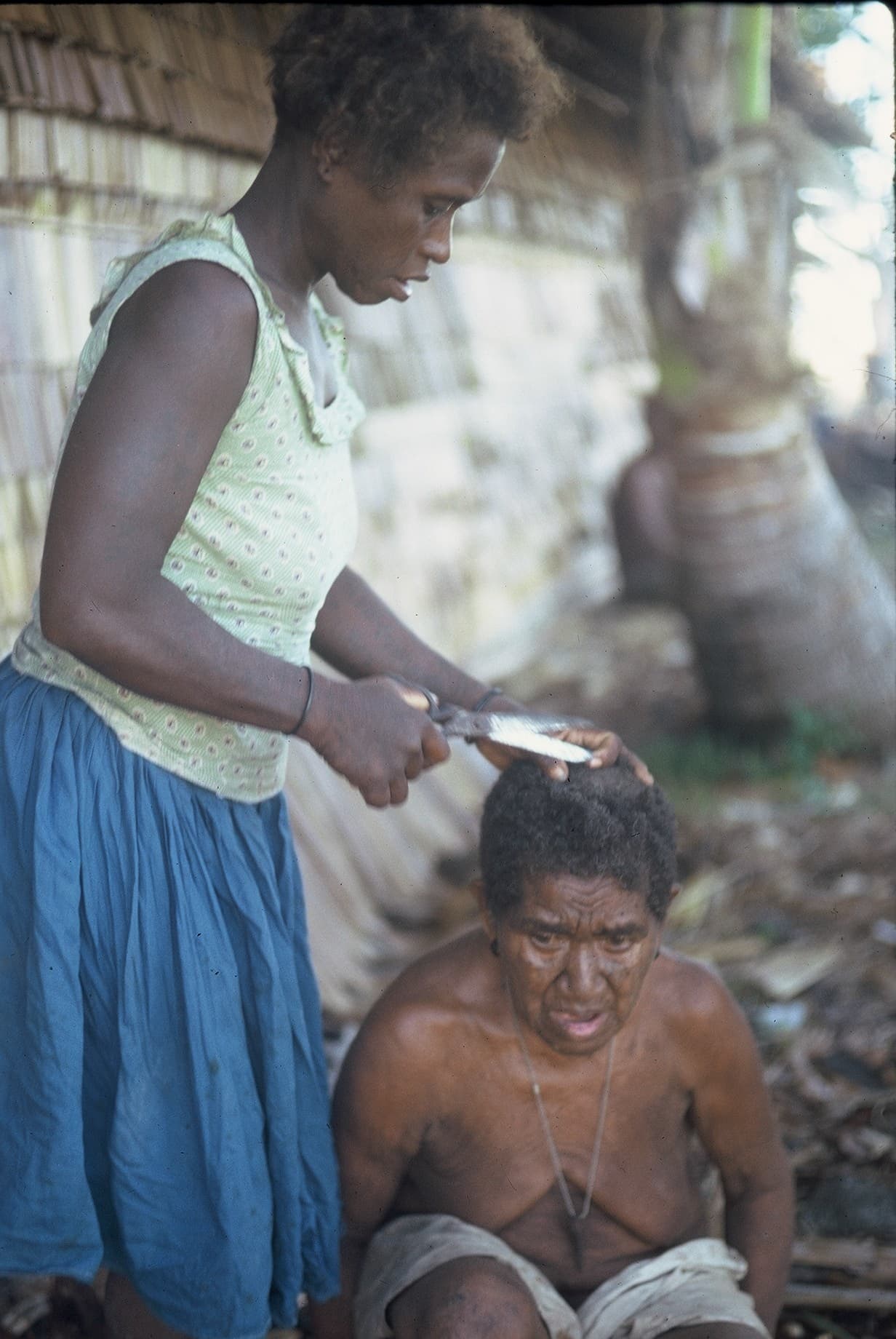 Widow having her head shaved in mourning