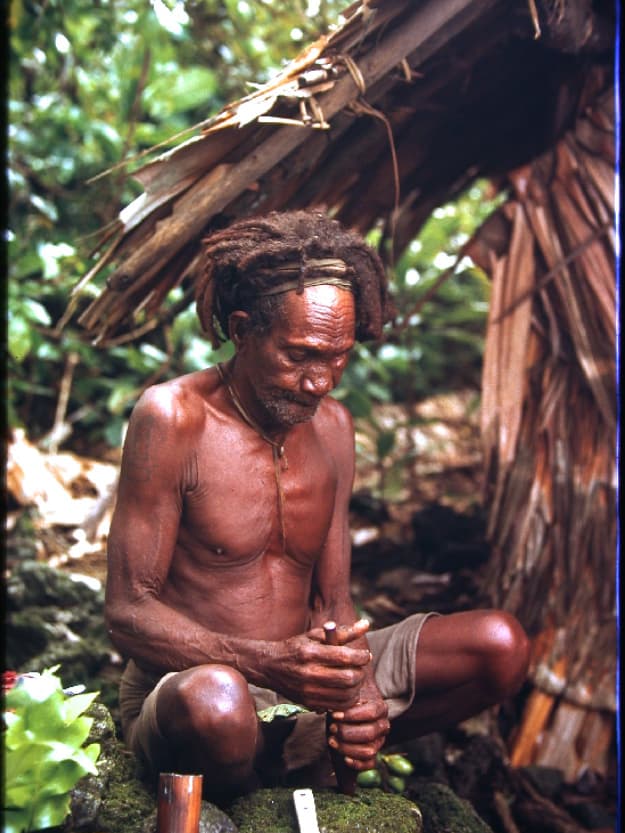 High priest Magi at his shrine, chewing betel