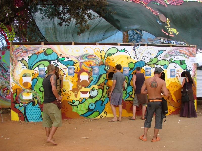 Painted mural wall with visitors in front