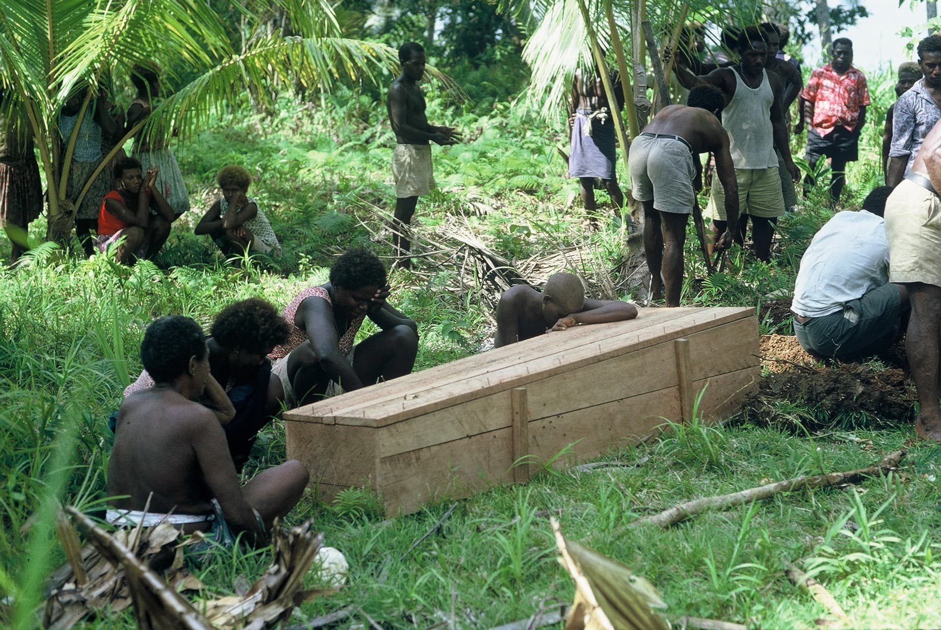 Mourners at a graveside before burial