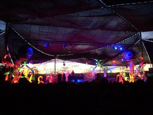 Lit stage under a draped ceiling at night