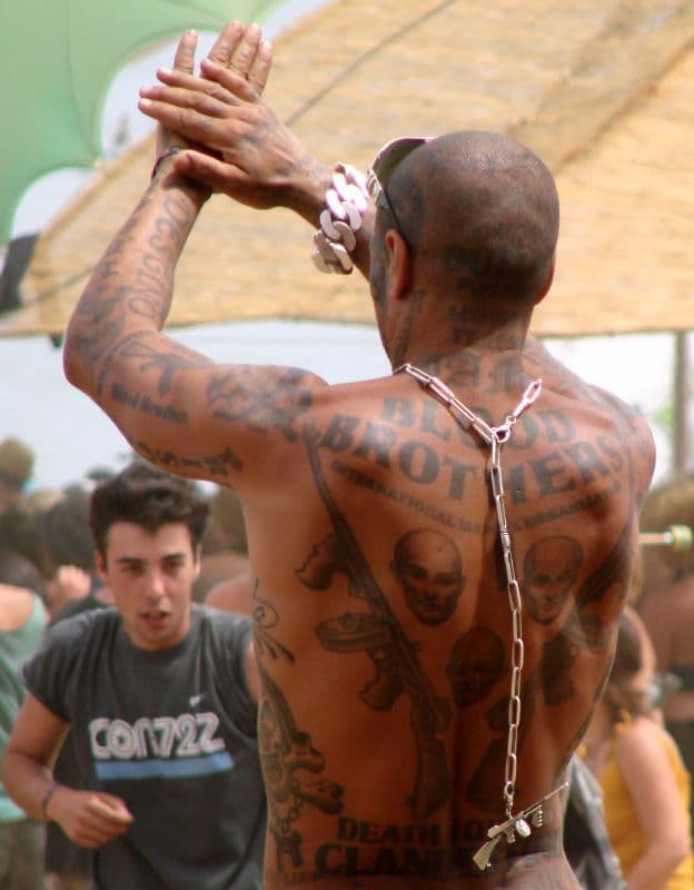 Tattooed dancer with raised hands