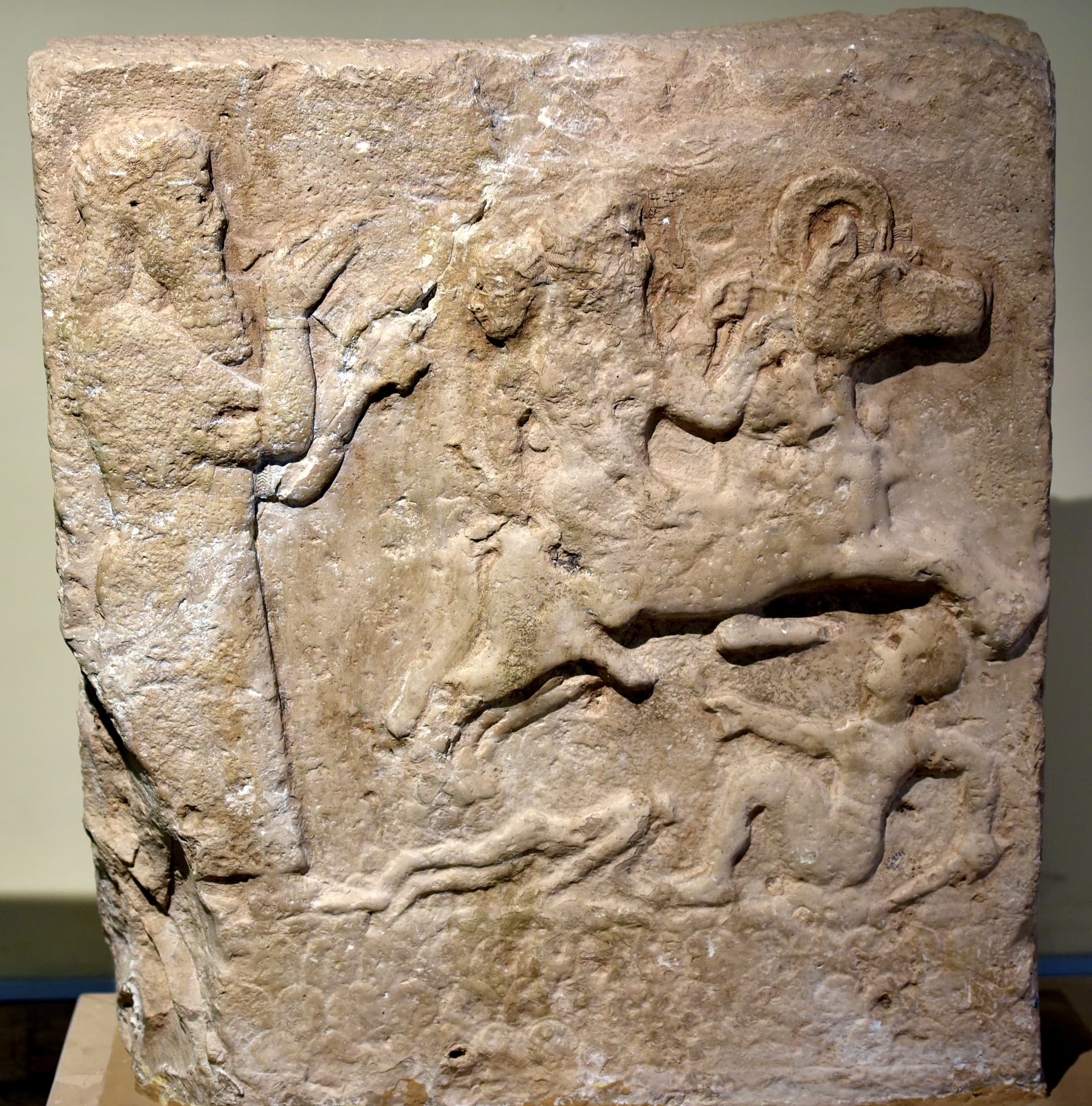 Assyrian wall relief showing a scribe and a horseman trampling enemies. From Anah, Iraq. Iraq Museum