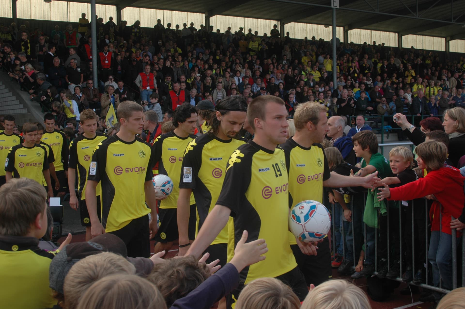 Borussia Dortmund Squad (before a football match and greeted by BVB fans)
