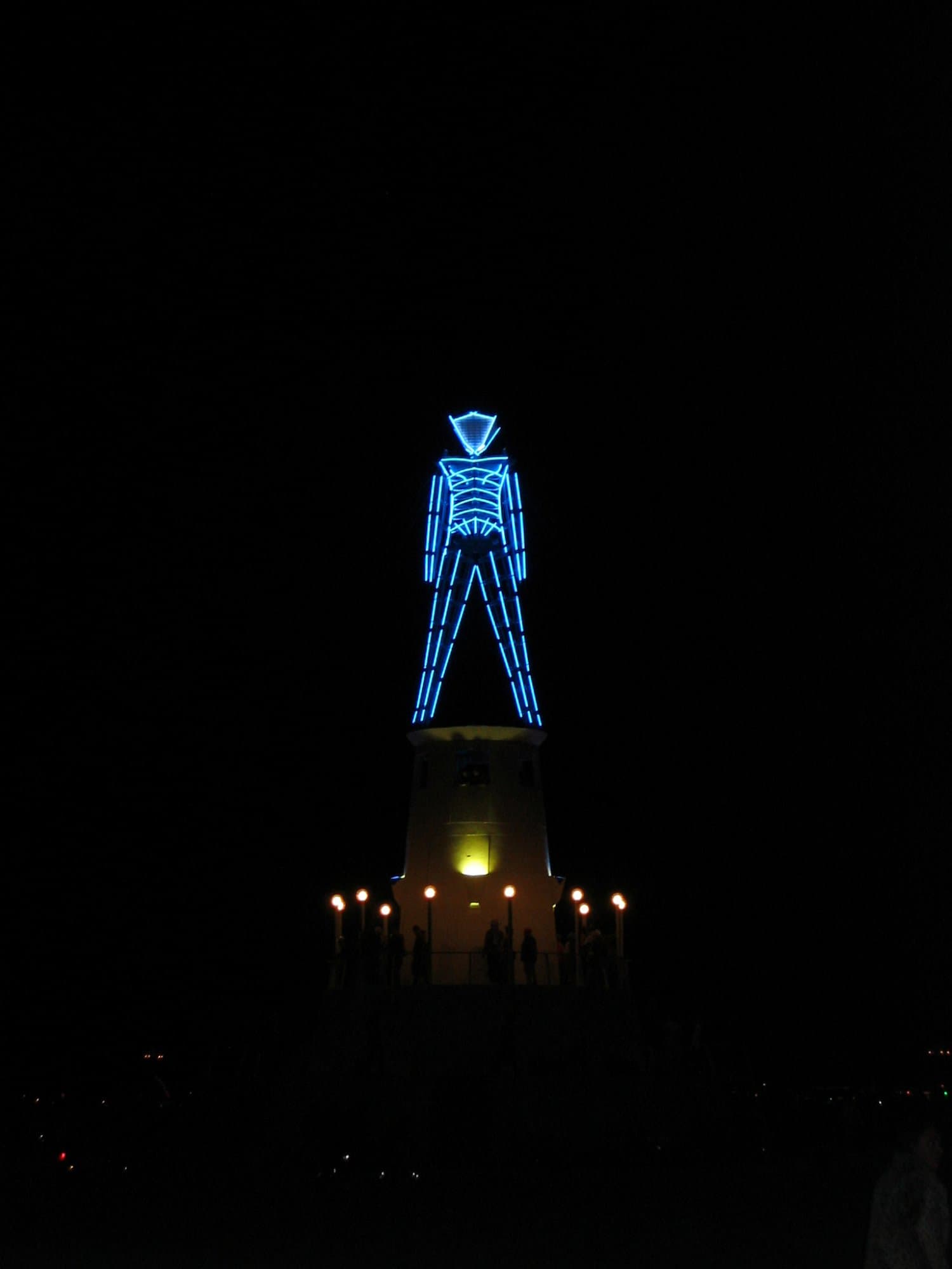 The blue-neon Man on the lighthouse · 2/5