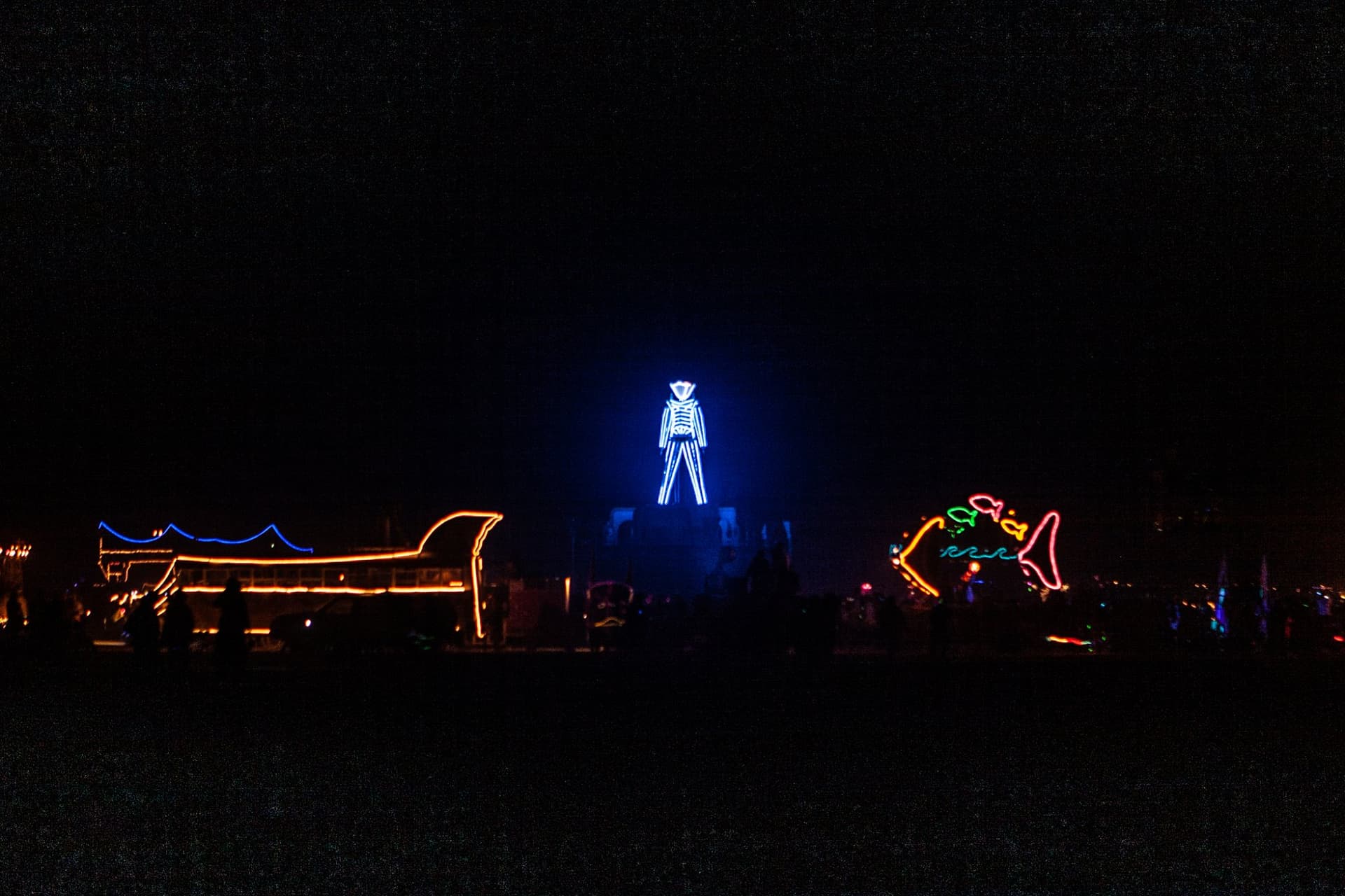 The blue-neon Man over the city · 1/5