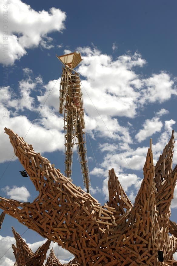 Wooden Man Effigy Rising from a Splayed Base
