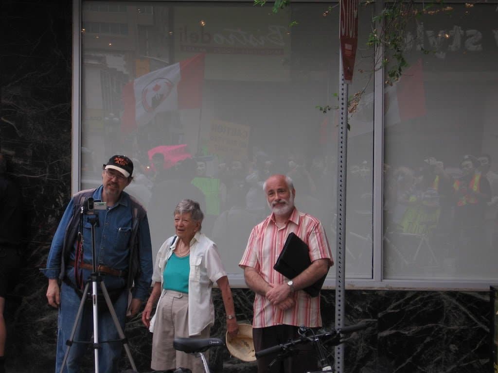 Critics watch a protest arrive in Toronto
