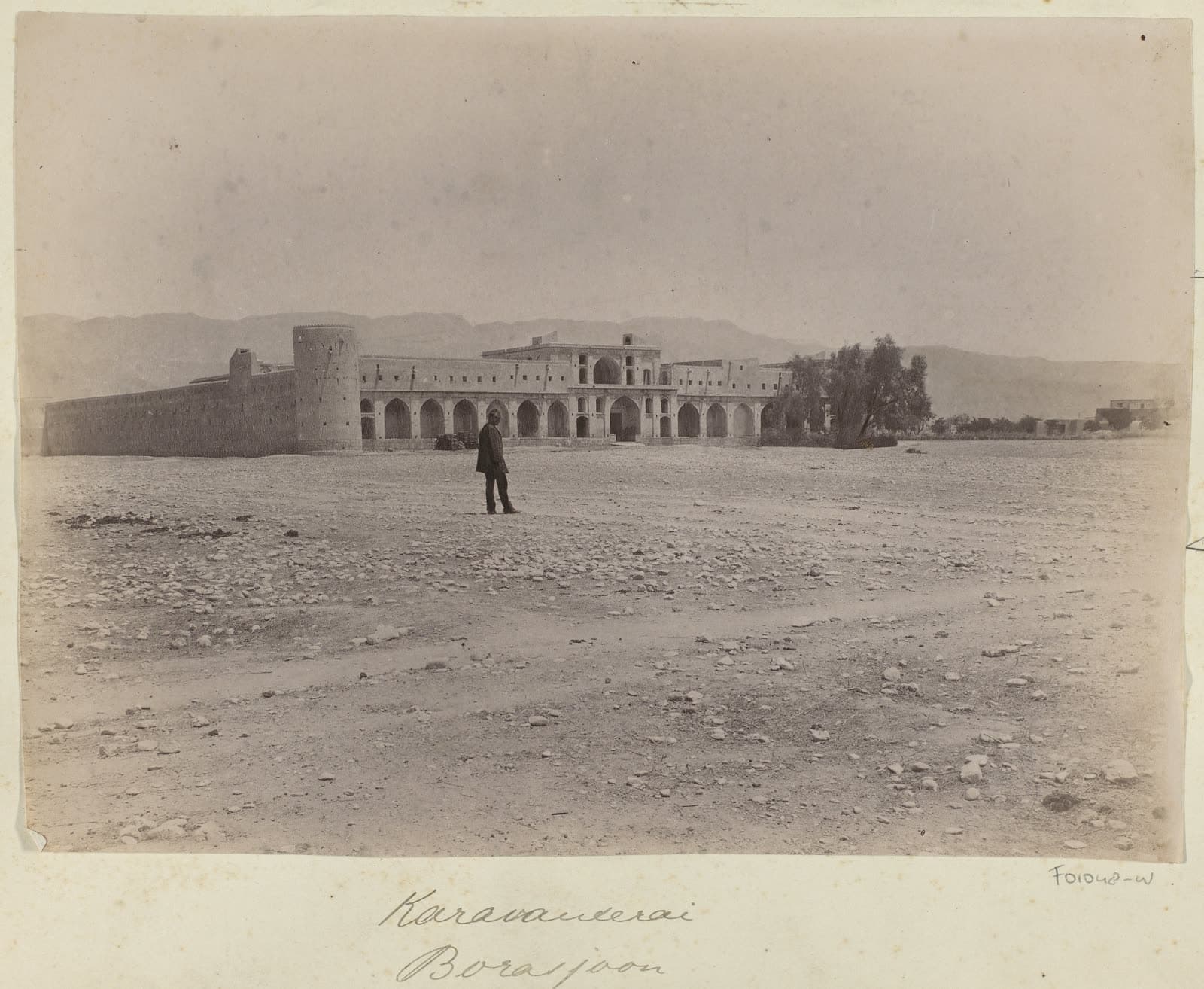 A caravanserai on the plain near Borazjan, a man in the foreground