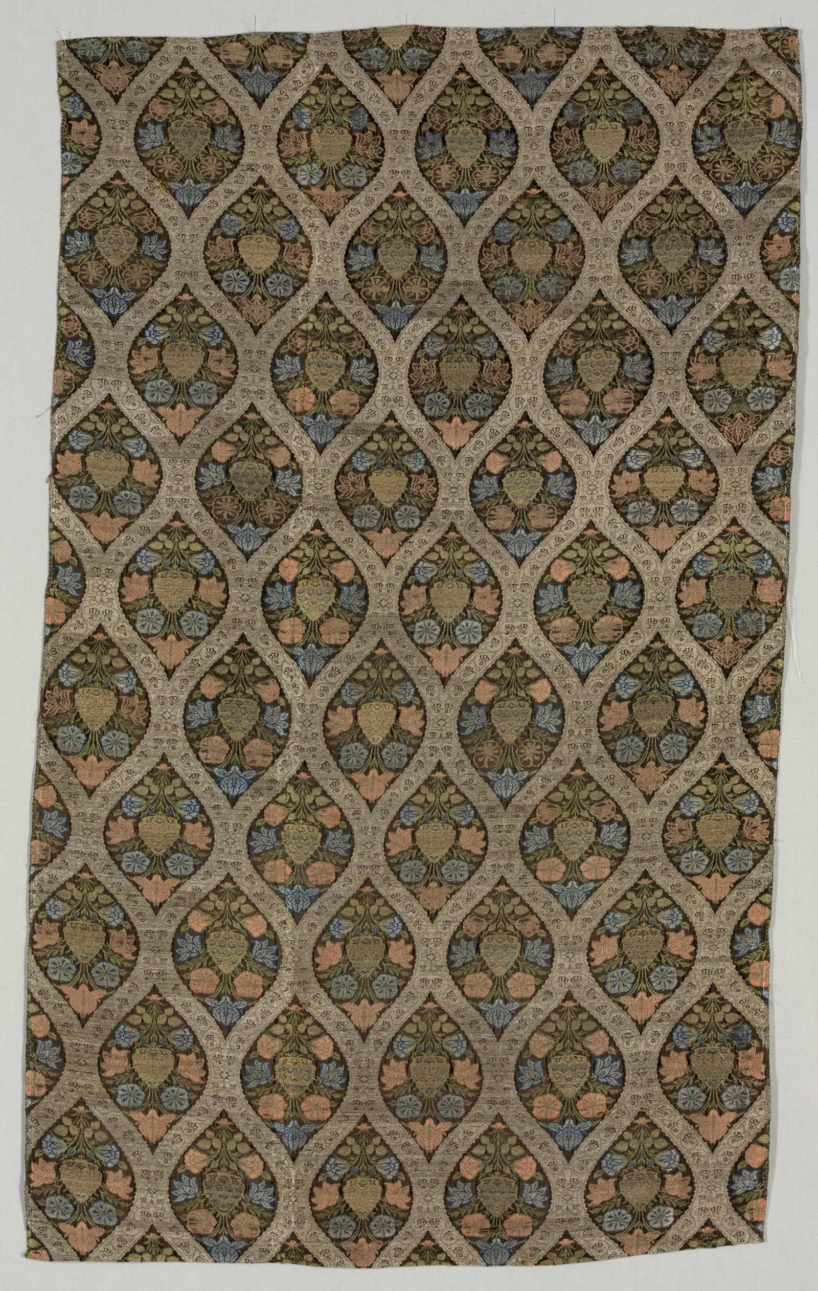 Lampas fragment with blossoms in ogival lattice