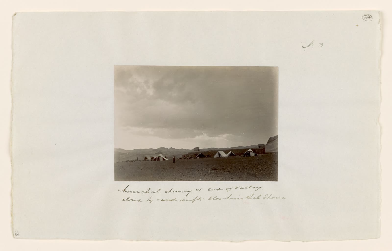 Tents and a fort at Amir Chah, with sand drifts closing the valley