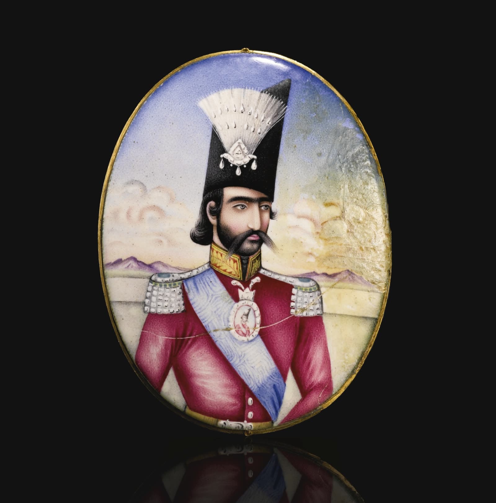 A Qajar enamelled portrait medallion of Nasir al-Din Shah, Persia, circa 1855