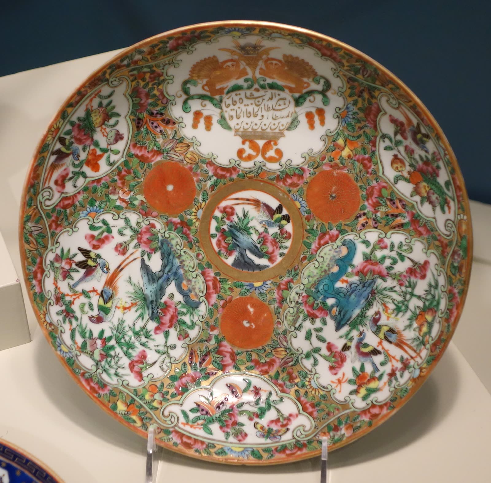 Dish in rose medallion pattern with the insignia of Naser al-Din Shah