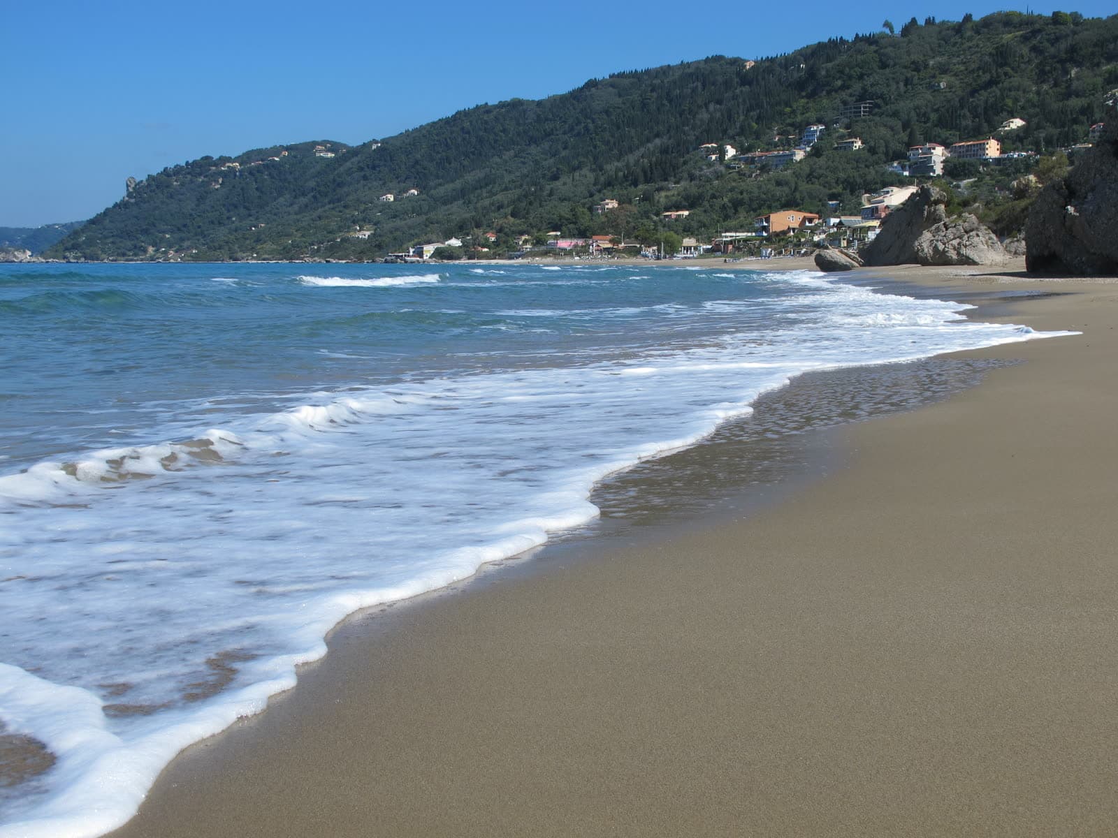 The sand and shallow water of Agios Gordios beach (2 of 6)