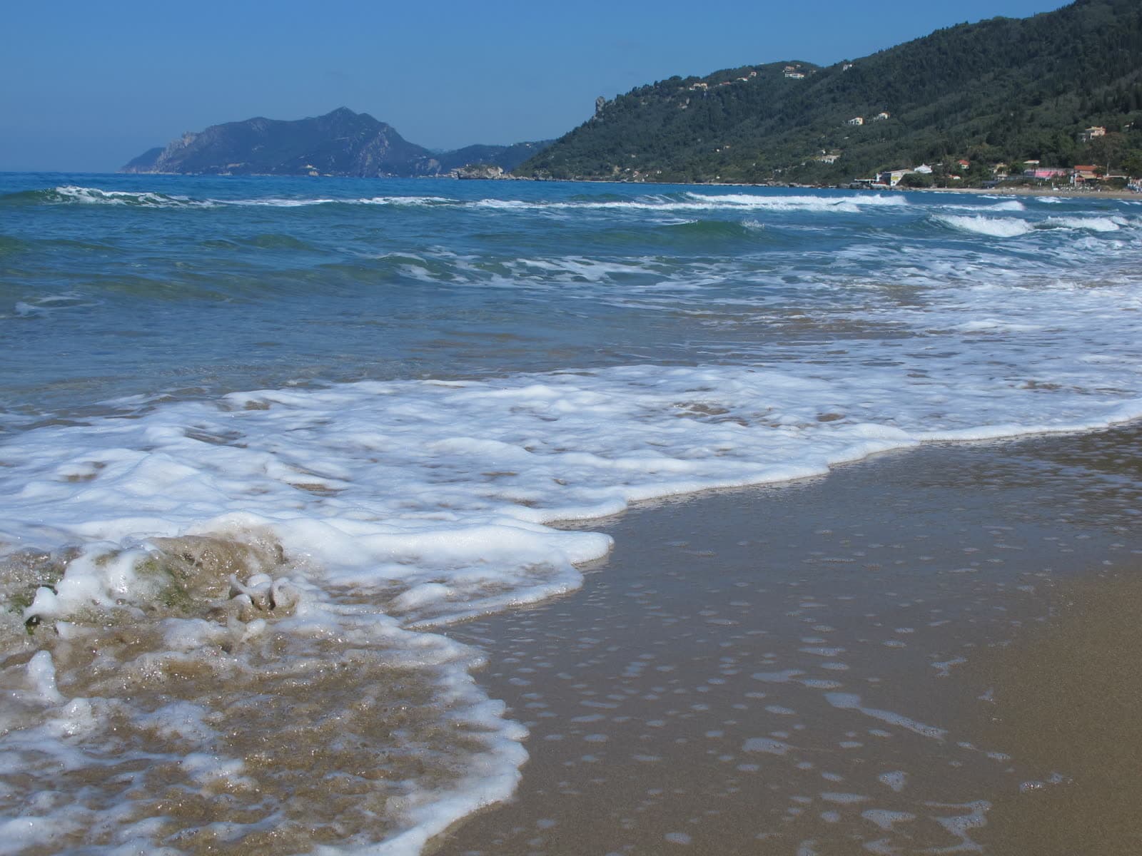 The sand and shallow water of Agios Gordios beach (3 of 6)