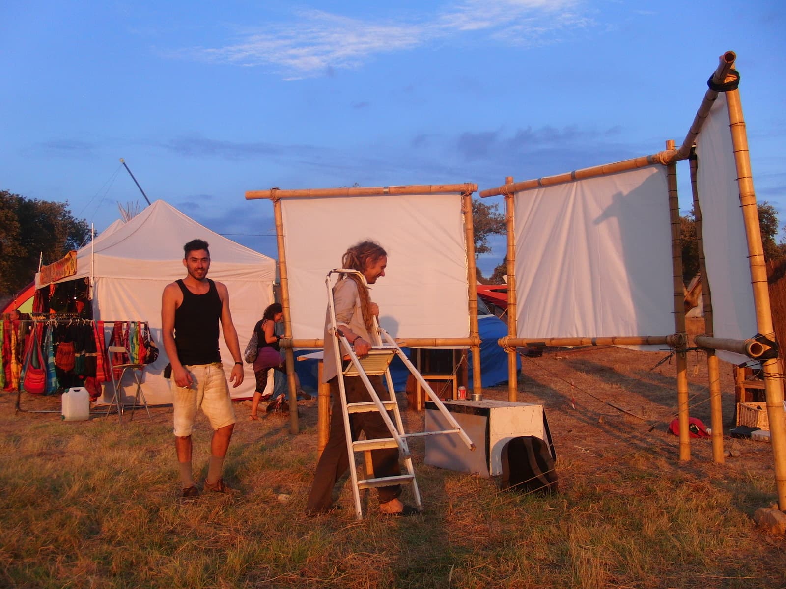 Raising a screen frame beside the tents, Boom 2010