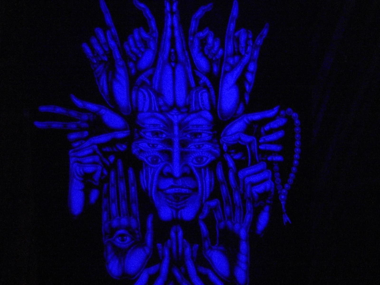 Ultraviolet mural of a many handed figure, Boom 2010