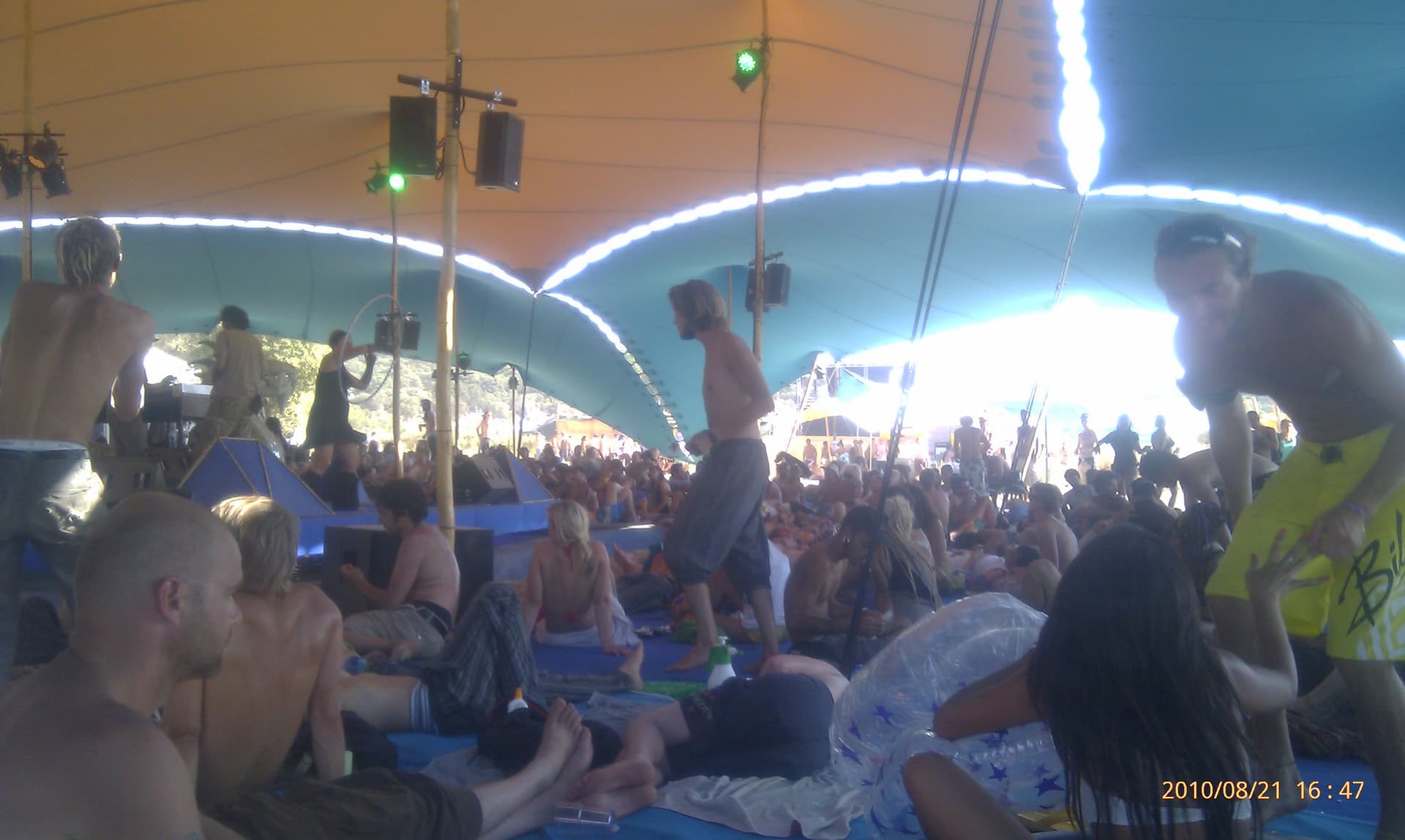 Seated crowd under the white stage canopy, Boom 2010