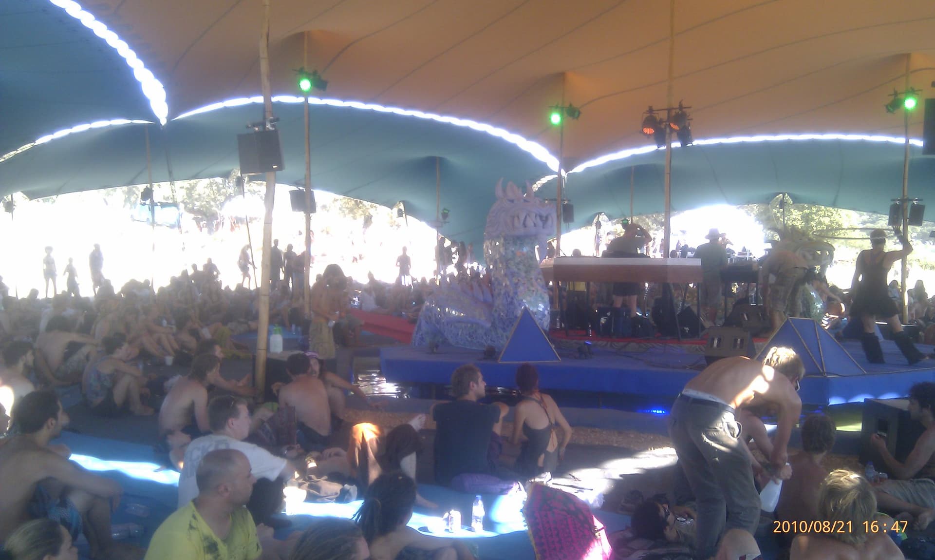 Crowd resting under the curved stage canopy, Boom 2010