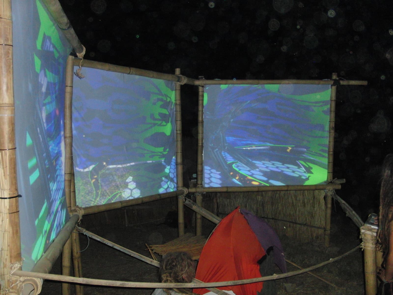 Curved bank of projection screens at night, Boom 2010