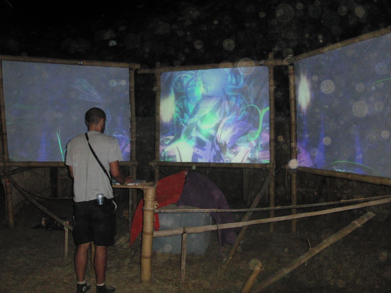 Visitor at a bamboo framed projection gallery, Boom 2010