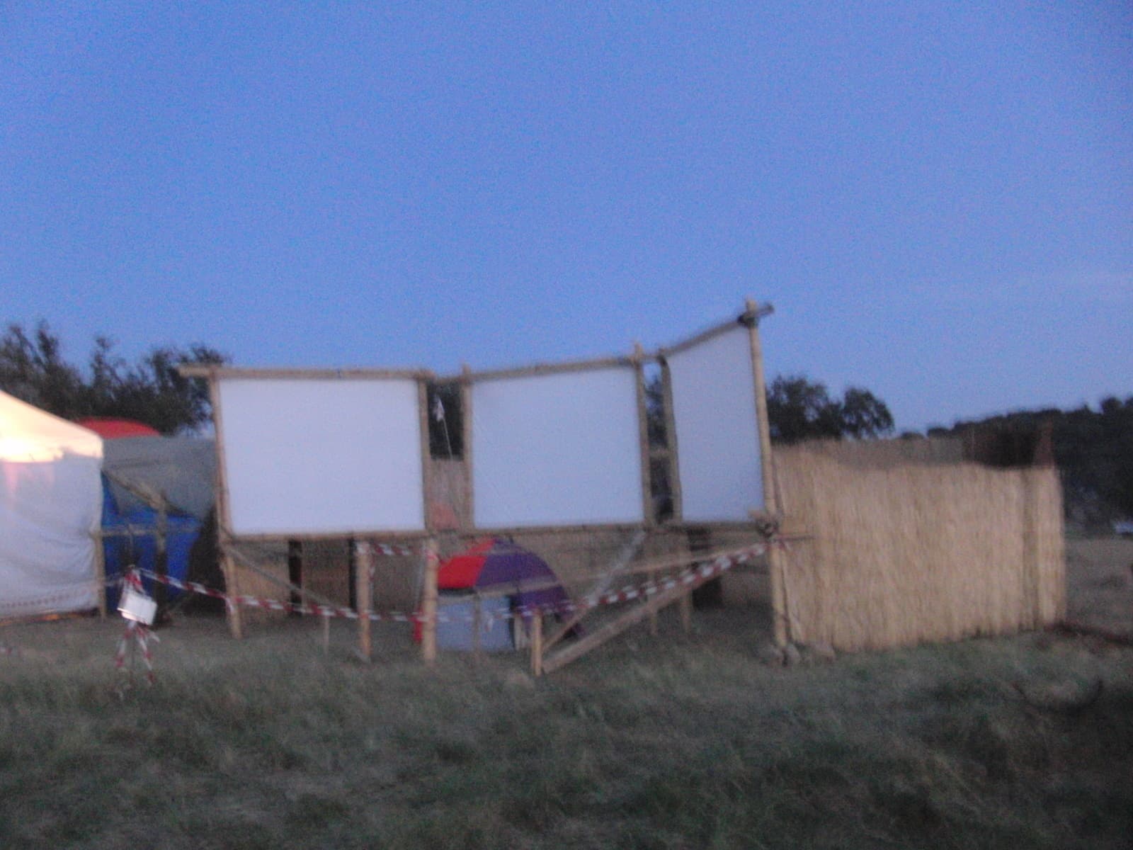 Blank screens and reed fence on the build site, Boom 2010