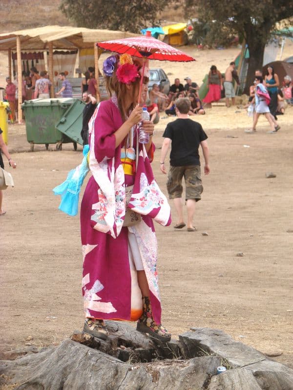 Costumed visitor with a parasol on the path