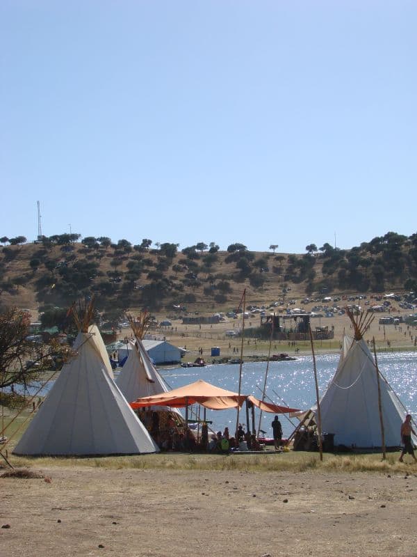 Tipis pitched beside the water