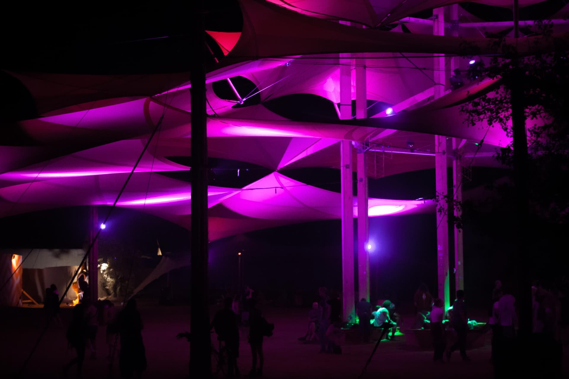 Structure lit in magenta at night