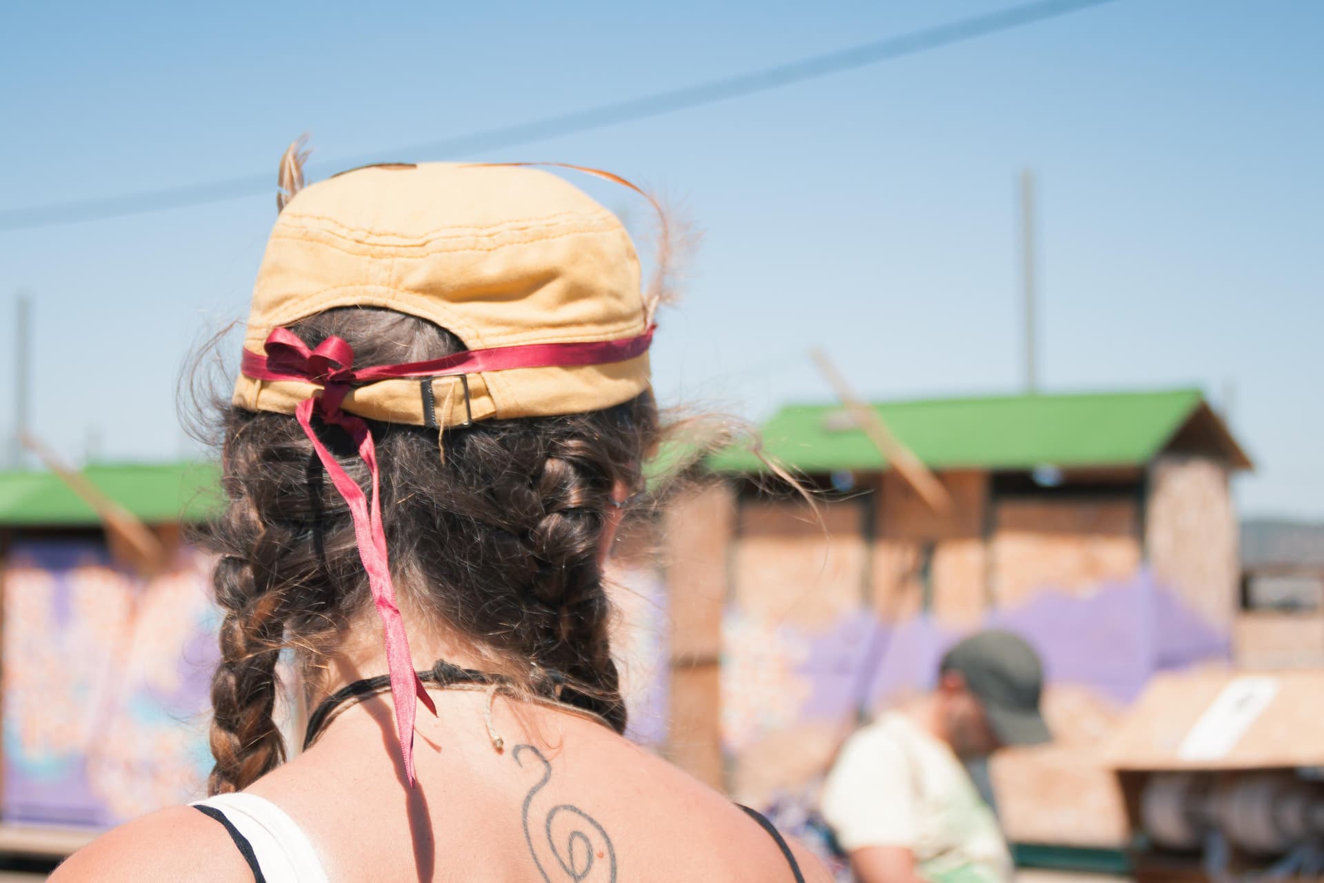 Visitor with a woven headpiece from behind